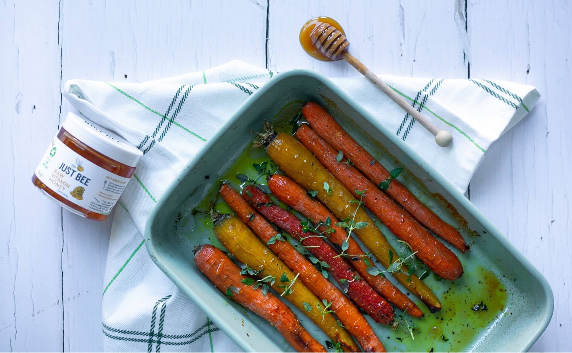 honey roasted carrots on a baking tray with honey